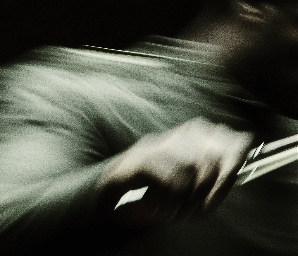Hands on strings, smeared by a long exposure under stage light